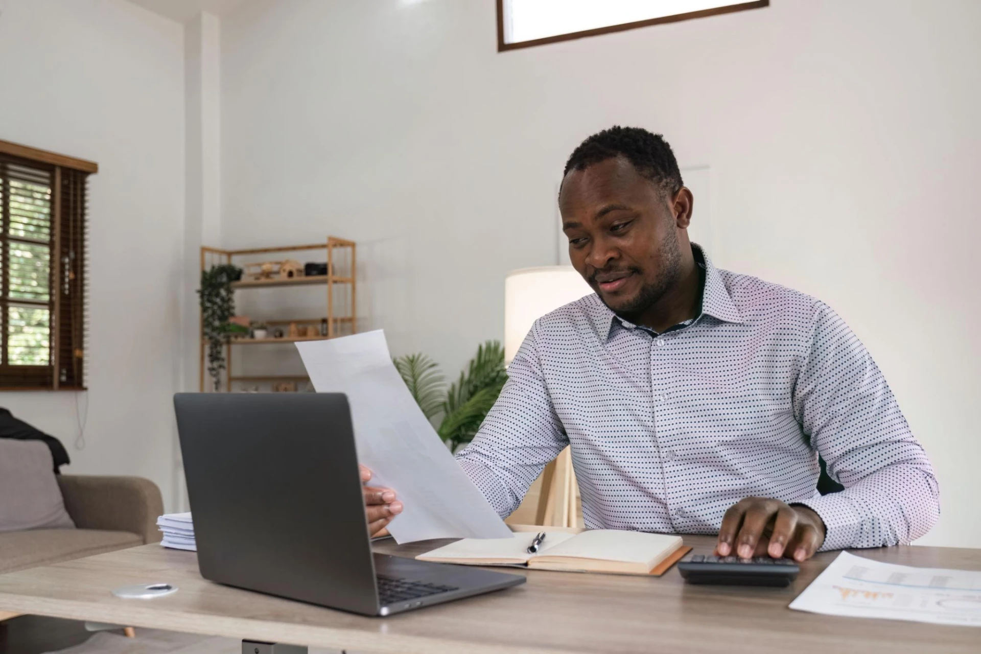 A business owner preparing invoices at his desk